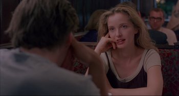 Movie still from “Before Sunrise” (1995), directed by Richard Linklater – A woman sitting in front of a man at a table; Close Up shot, Over the shoulder angle