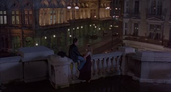 Movie still from “Before Sunrise” (1995), directed by Richard Linklater – A man and a woman sitting on a railing at night; Wide shot, High angle