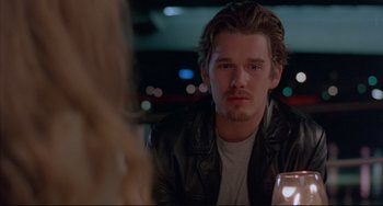 Movie still from “Before Sunrise” (1995), directed by Richard Linklater – A man sitting in front of a woman at a table; Close Up shot, Over the shoulder angle