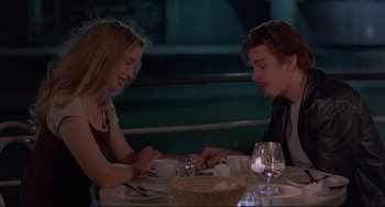 Movie still from “Before Sunrise” (1995), directed by Richard Linklater – A man and a woman sitting at a dinner table; Medium shot, High angle