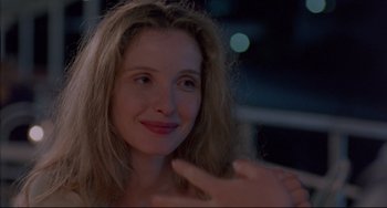 Movie still from “Before Sunrise” (1995), directed by Richard Linklater – A person with long blonde hair; Close Up shot, Over the shoulder angle