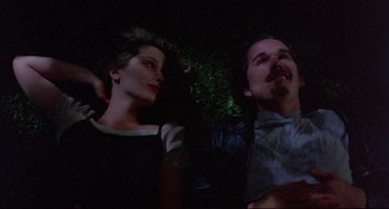 Movie still from “Before Sunrise” (1995), directed by Richard Linklater – A man and a woman sitting next to each other in the dark; Medium shot, Overhead angle