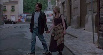 Movie still from “Before Sunrise” (1995), directed by Richard Linklater – A man and a woman walking down a street holding hands; Medium shot, Low angle