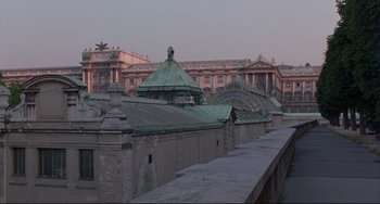 Movie still from “Before Sunrise” (1995), directed by Richard Linklater – A view of a large building with a green roof; Extreme Wide shot, Low angle