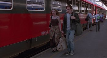 Movie still from “Before Sunrise” (1995), directed by Richard Linklater – A man and a woman walking on a train platform; Wide shot, Low angle
