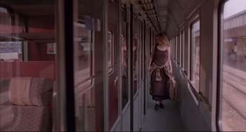Movie still from “Before Sunrise” (1995), directed by Richard Linklater – A woman walking down a train with a suitcase; Wide shot, Low angle