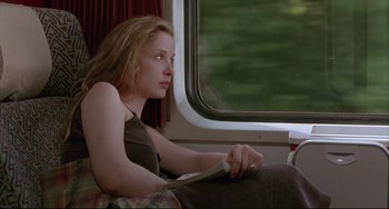 Movie still from “Before Sunrise” (1995), directed by Richard Linklater – A woman sitting on a train looking out the window; Medium shot, Low angle
