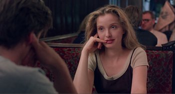 Movie still from “Before Sunset” (2004), directed by Richard Linklater – A woman sitting in front of a mirror with her hand under her chin; Close Up shot, Over the shoulder angle