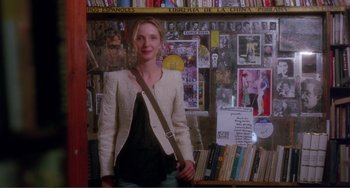 Movie still from “Before Sunset” (2004), directed by Richard Linklater – A woman standing in front of a wall covered with books; Medium shot, Over the shoulder angle