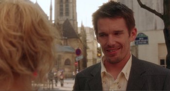 Movie still from “Before Sunset” (2004), directed by Richard Linklater – A person wearing a suit on a city street; Close Up shot, Over the shoulder angle