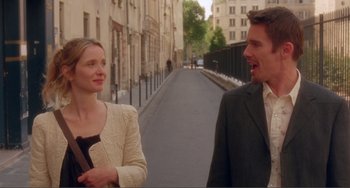 Movie still from “Before Sunset” (2004), directed by Richard Linklater – A man and a woman standing next to each other on the street; Medium shot, Over the shoulder angle