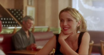 Movie still from “Before Sunset” (2004), directed by Richard Linklater – A woman sitting in front of a man at a table; Close Up shot, Over the shoulder angle