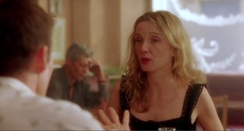Movie still from “Before Sunset” (2004), directed by Richard Linklater – A woman sitting in front of a man at a table; Medium shot, Over the shoulder angle