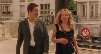 Movie still from “Before Sunset” (2004), directed by Richard Linklater – A man and a woman walking down a sidewalk; Medium shot, Over the shoulder angle