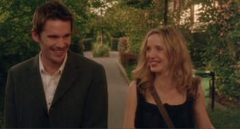 Movie still from “Before Sunset” (2004), directed by Richard Linklater – A man and a woman walking down a sidewalk; Medium shot, Over the shoulder angle
