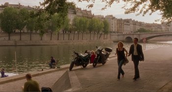 Movie still from “Before Sunset” (2004), directed by Richard Linklater – Two motorcycles parked next to each other near a body of water; Wide shot, High angle