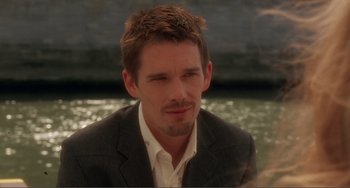 Movie still from “Before Sunset” (2004), directed by Richard Linklater – A person wearing a suit and tie; Close Up shot, Over the shoulder angle