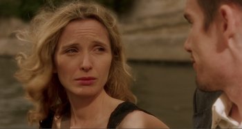 Movie still from “Before Sunset” (2004), directed by Richard Linklater – A woman is looking at the camera while a man looks at her; Close Up shot, Over the shoulder angle