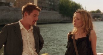 Movie still from “Before Sunset” (2004), directed by Richard Linklater – A man and a woman standing next to a body of water; Medium shot, Over the shoulder angle