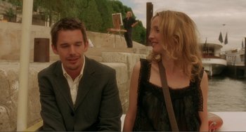Movie still from “Before Sunset” (2004), directed by Richard Linklater – A man and a woman sitting next to each other; Medium shot, Over the shoulder angle