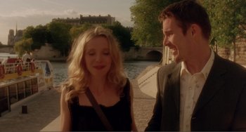 Movie still from “Before Sunset” (2004), directed by Richard Linklater – A man and a woman standing next to each other on a sidewalk; Medium shot, Over the shoulder angle