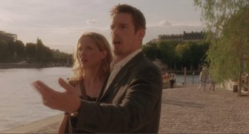 Movie still from “Before Sunset” (2004), directed by Richard Linklater – A man and a woman standing next to each other; Medium shot, Over the shoulder angle