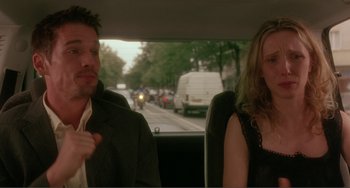 Movie still from “Before Sunset” (2004), directed by Richard Linklater – A man and a woman sitting in the back of a car; Medium shot, Over the shoulder angle