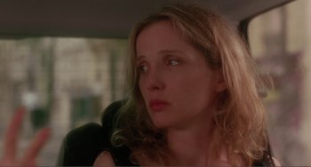 Movie still from “Before Sunset” (2004), directed by Richard Linklater – A person with long blonde hair; Close Up shot, Over the shoulder angle