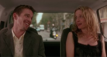 Movie still from “Before Sunset” (2004), directed by Richard Linklater – A man and a woman sitting in the back of a car; Medium shot, Over the shoulder angle