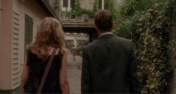 Movie still from “Before Sunset” (2004), directed by Richard Linklater – A man and a woman walking down a street; Wide shot, Over the shoulder angle