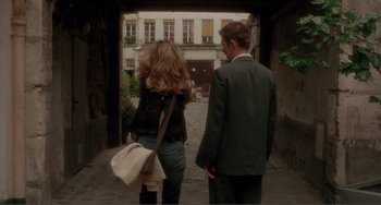 Movie still from “Before Sunset” (2004), directed by Richard Linklater – A man and a woman walking down a street; Wide shot, Over the shoulder angle