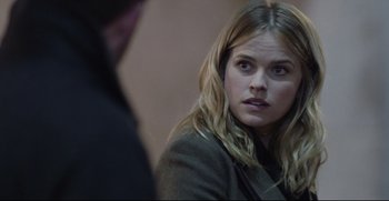 Movie still from “Before We Go” (2014), directed by Chris Evans – A woman sitting in front of a man in front of a wall; Close Up shot, Over the shoulder angle