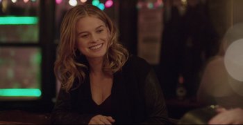 Movie still from “Before We Go” (2014), directed by Chris Evans – A woman smiles while sitting at a table; Close Up shot, Over the shoulder angle