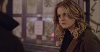 Movie still from “Before We Go” (2014), directed by Chris Evans – A woman with long blonde curly hair wearing a black top; Close Up shot, Over the shoulder angle