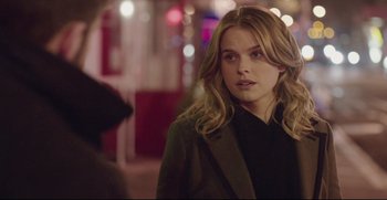 Movie still from “Before We Go” (2014), directed by Chris Evans – A beautiful young woman in a black shirt and a black jacket; Close Up shot, Over the shoulder angle