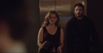 Movie still from “Before We Go” (2014), directed by Chris Evans – A man and a woman standing next to each other in an elevator; Medium shot, Low angle