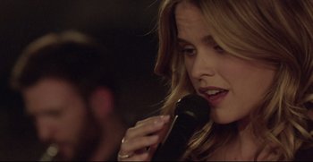 Movie still from “Before We Go” (2014), directed by Chris Evans – A person holding a microphone; Close Up shot, Over the shoulder angle