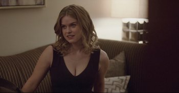 Movie still from “Before We Go” (2014), directed by Chris Evans – A beautiful young lady sitting on top of a couch; Medium shot, Over the shoulder angle