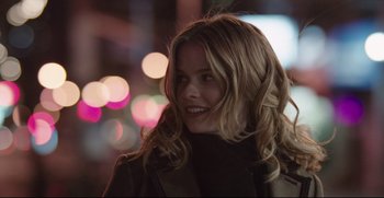 Movie still from “Before We Go” (2014), directed by Chris Evans – A woman with long blonde hair smiles at the camera; Close Up shot, Over the shoulder angle