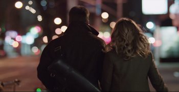Movie still from “Before We Go” (2014), directed by Chris Evans – A man and a woman are walking in the dark; Medium shot, Over the shoulder angle
