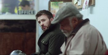 Movie still from “Before We Go” (2014), directed by Chris Evans – A man in a hat and jacket looking at another man in a hat; Medium shot, Over the shoulder angle