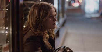 Movie still from “Before We Go” (2014), directed by Chris Evans – A woman sitting on the side of the street at night; Close Up shot, Over the shoulder angle