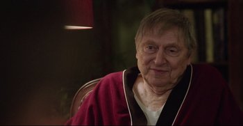 Movie still from “Before We Go” (2014), directed by Chris Evans – An older man sitting in a chair wearing a robe; Close Up shot, Over the shoulder angle