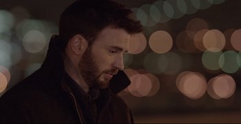Movie still from “Before We Go” (2014), directed by Chris Evans – A man with a beard is talking on a cell phone; Close Up shot, Over the shoulder angle