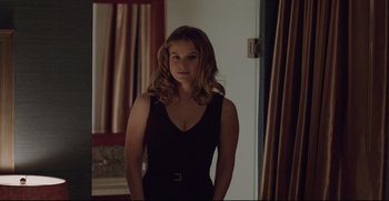 Movie still from “Before We Go” (2014), directed by Chris Evans – A woman in a black dress standing in front of a mirror; Medium shot, Over the shoulder angle