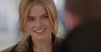 Movie still from “Before We Go” (2014), directed by Chris Evans – A person with blonde hair smiling; Close Up shot, Over the shoulder angle