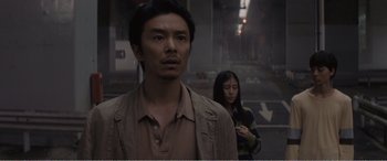 A man and a woman standing next to each other on the street