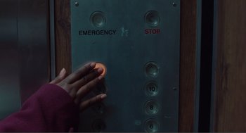 Movie still from “Being John Malkovich” (1999), directed by Spike Jonze – A person pressing a button on a metal panel; Extreme Close Up shot, Overhead angle