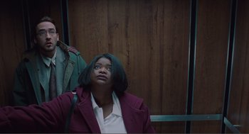 Movie still from “Being John Malkovich” (1999), directed by Spike Jonze – A woman in a purple jacket is looking up; Medium shot, Low angle