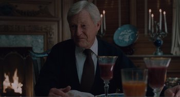 Movie still from “Being John Malkovich” (1999), directed by Spike Jonze – An older man sitting at a table in a restaurant; Medium shot, Over the shoulder angle